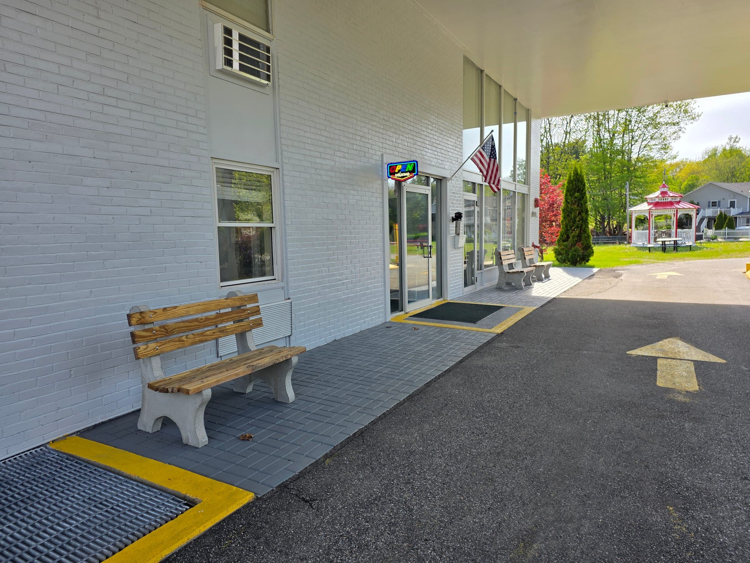 Saffron Inn front driveway approach — the entry from Center Street with the building's red cupola roof